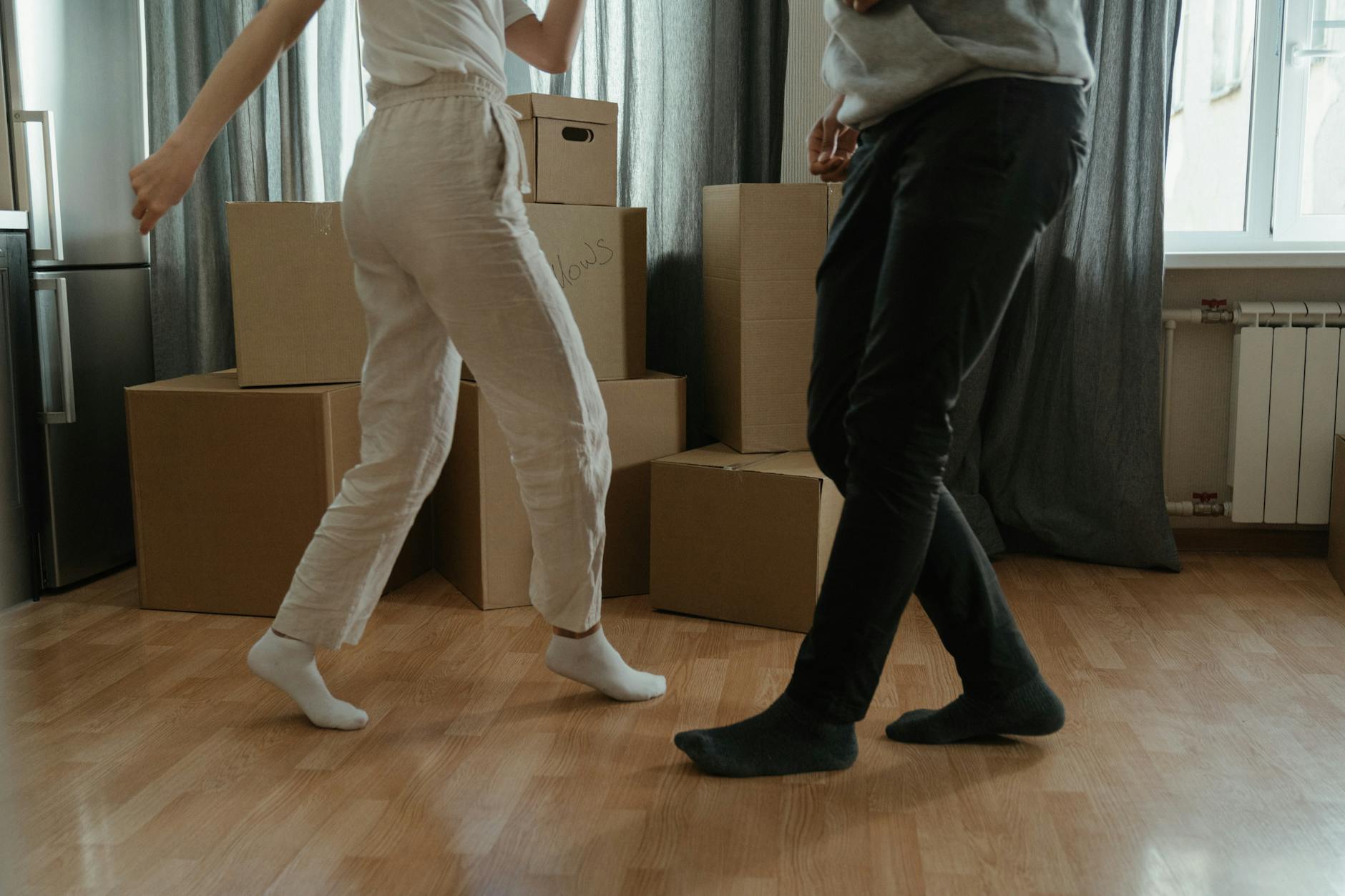 man in white t shirt and black pants holding woman in white t shirt